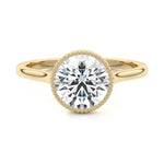 Round cut Moissanite lab grown diamond engagement ring round shank with a bezel setting, on a gold band, against a white background.Moissanite engagement ring cape town south africa grand diamonds ralph jacobs jeulia 