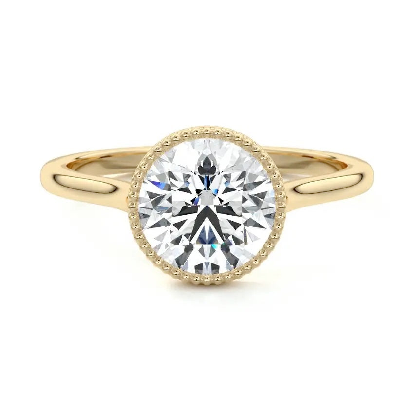 Round cut Moissanite lab grown diamond engagement ring round shank with a bezel setting, on a gold band, against a white background.Moissanite engagement ring cape town south africa grand diamonds ralph jacobs jeulia 