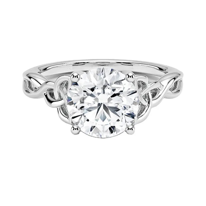 Round cut Moissanite lab grown diamond engagement ring infinity shank with a ornate setting, and intricate basket design on a gold band, against a white background.Moissanite engagement ring cape town south africa grand diamonds ralph jacobs jeuli