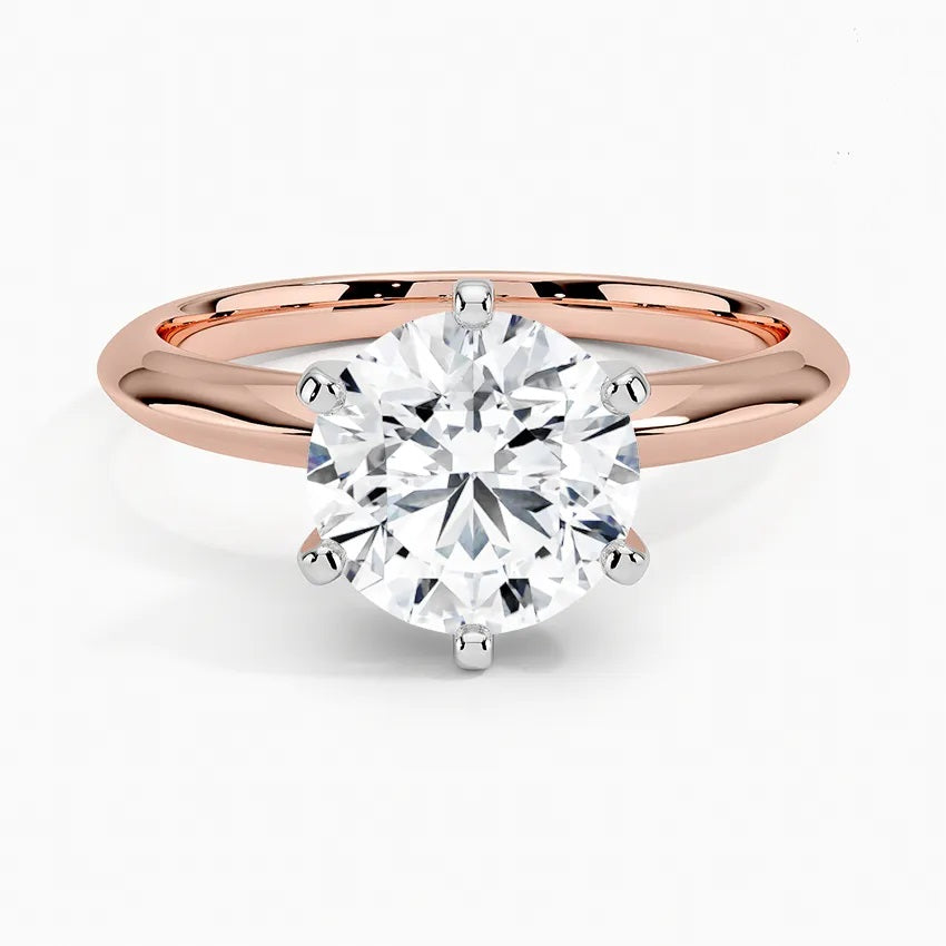 Round cut Moissanite lab grown diamond engagement ring round shank with a six claw setting, on a gold band, against a white background.Moissanite engagement ring cape town south africa grand diamonds ralph jacobs jeuli