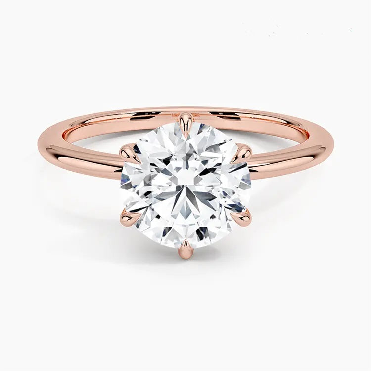 Round cut Moissanite lab grown diamond engagement ring round band with a six claw setting, on a gold band, against a white background.Moissanite engagement ring cape town south africa grand diamonds ralph jacobs jeulia  