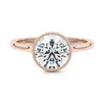 Round cut Moissanite lab grown diamond engagement ring round shank with a bezel setting, on a gold band, against a white background.Moissanite engagement ring cape town south africa grand diamonds ralph jacobs jeulia 