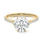 Round cut Moissanite lab grown diamond engagement ring with cathedral  set main stone and tapered pave set shank on a gold band, against a white background.Moissanite engagement ring cape town south africa grand diamonds ralph jacobs jeulia 