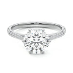 Round cut Moissanite lab grown diamond engagement ring with cathedral  set main stone and tapered pave set shank on a gold band, against a white background.Moissanite engagement ring cape town south africa grand diamonds ralph jacobs jeulia 