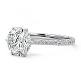 Round cut Moissanite lab grown diamond engagement ring with cathedral  set main stone and tapered pave set shank on a gold band, against a white background.Moissanite engagement ring cape town south africa grand diamonds ralph jacobs jeulia 