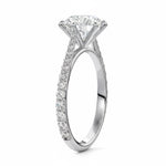 Round cut Moissanite lab grown diamond engagement ring with cathedral  set main stone and tapered pave set shank on a gold band, against a white background.Moissanite engagement ring cape town south africa grand diamonds ralph jacobs jeulia 