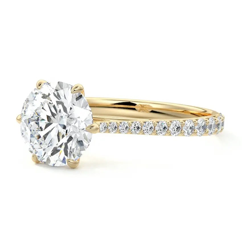 Round cut Moissanite lab grown diamond engagement ring with cathedral  set main stone and tapered pave set shank on a gold band, against a white background.Moissanite engagement ring cape town south africa grand diamonds ralph jacobs jeulia 