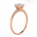 Round cut Moissanite lab grown diamond engagement ring with pave set shank with six  prong setting, on a gold band, against a white background.Moissanite engagement ring cape town south africa grand diamonds ralph jacobs jeulia 