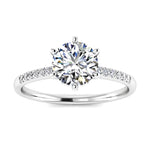 Round cut Moissanite lab grown diamond engagement ring with pave set shank with six  prong setting, on a gold band, against a white background.Moissanite engagement ring cape town south africa grand diamonds ralph jacobs jeulia 