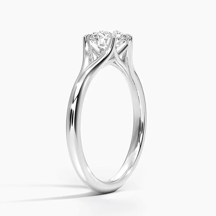 Round cut Split Shank Moissanite lab grown diamond engagement ring round shank with a six claw setting, on a gold band, against a white background.Moissanite engagement ring cape town south africa grand diamonds ralph jacobs jeuli