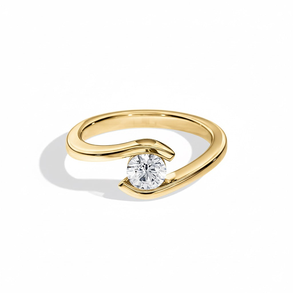 Engagement ring round cut Moissanite lab grown diamond tension set shank with a four claw setting, on a gold band, against a white background.Moissanite engagement ring cape town south africa grand diamonds ralph jacobs jeulia 