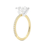 Round cut Moissanite lab grown diamond engagement ring with two tone design, yellow and white gold, pave set band, against a white background.Moissanite engagement ring cape town south africa grand diamonds ralph jacobs jeulia 