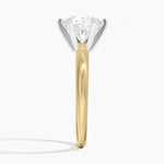 Round cut Moissanite lab grown diamond engagement ring round shank with a six claw setting, on a gold band, against a white background.Moissanite engagement ring cape town south africa grand diamonds ralph jacobs jeuli