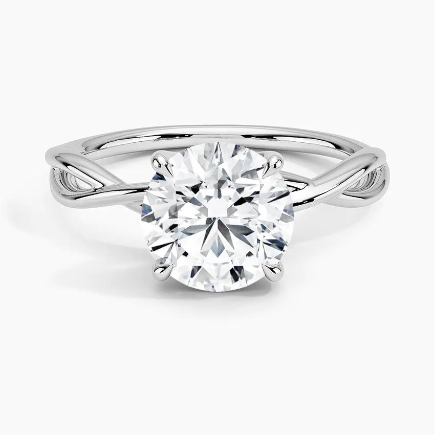 Round cut Moissanite lab grown diamond engagement ring twisted  band with a four claw setting, on a gold band, against a white background.Moissanite engagement ring cape town south africa grand diamonds ralph jacobs jeulia  