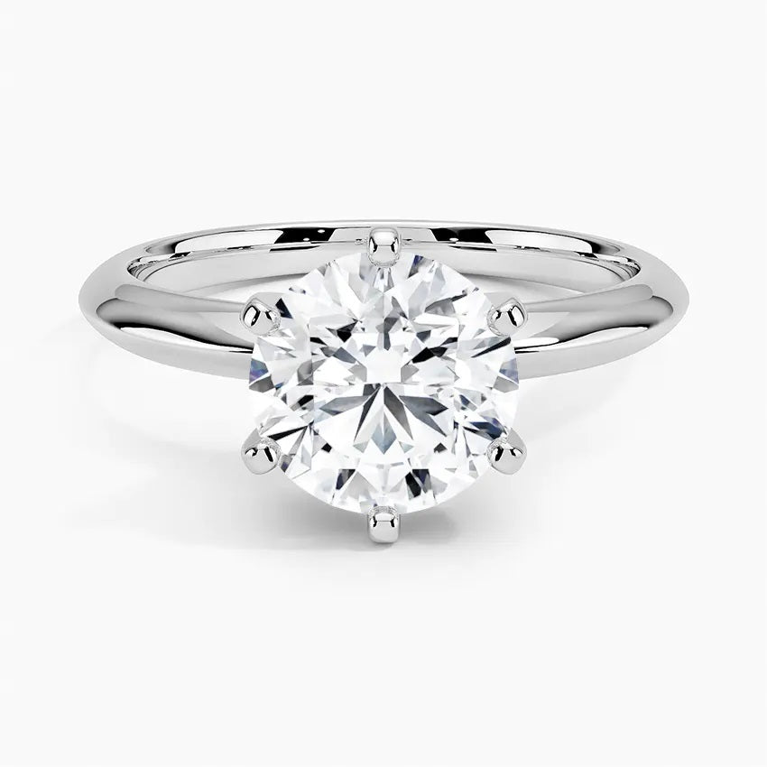 Round cut Moissanite lab grown diamond engagement ring round shank with a six claw setting, on a gold band, against a white background.Moissanite engagement ring cape town south africa grand diamonds ralph jacobs jeuli