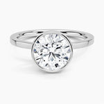 Round cut Moissanite lab grown diamond engagement ring round shank with a bezel setting, on a gold band, against a white background.Moissanite engagement ring cape town south africa grand diamonds ralph jacobs jeulia 