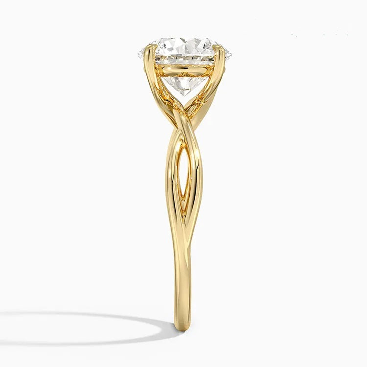Round cut Moissanite lab grown diamond engagement ring twisted  band with a four claw setting, on a gold band, against a white background.Moissanite engagement ring cape town south africa grand diamonds ralph jacobs jeulia  
