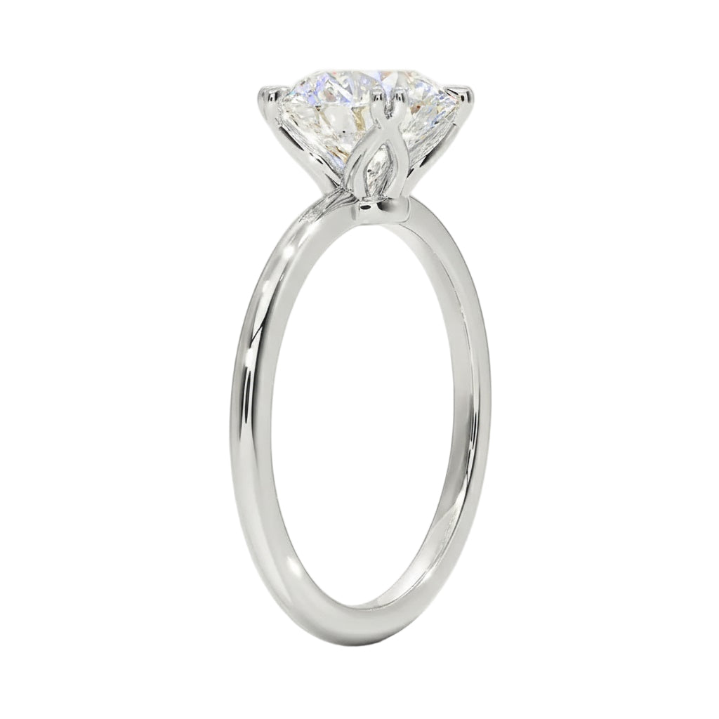 Engagement ring round cut Moissanite lab grown diamond round shank with a four cat double claw setting, on a gold band, against a white background.Moissanite engagement ring cape town south africa grand diamonds ralph jacobs jeulia 