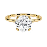 Engagement ring round cut Moissanite lab grown diamond round shank with a four cat double claw setting, on a gold band, against a white background.Moissanite engagement ring cape town south africa grand diamonds ralph jacobs jeulia 