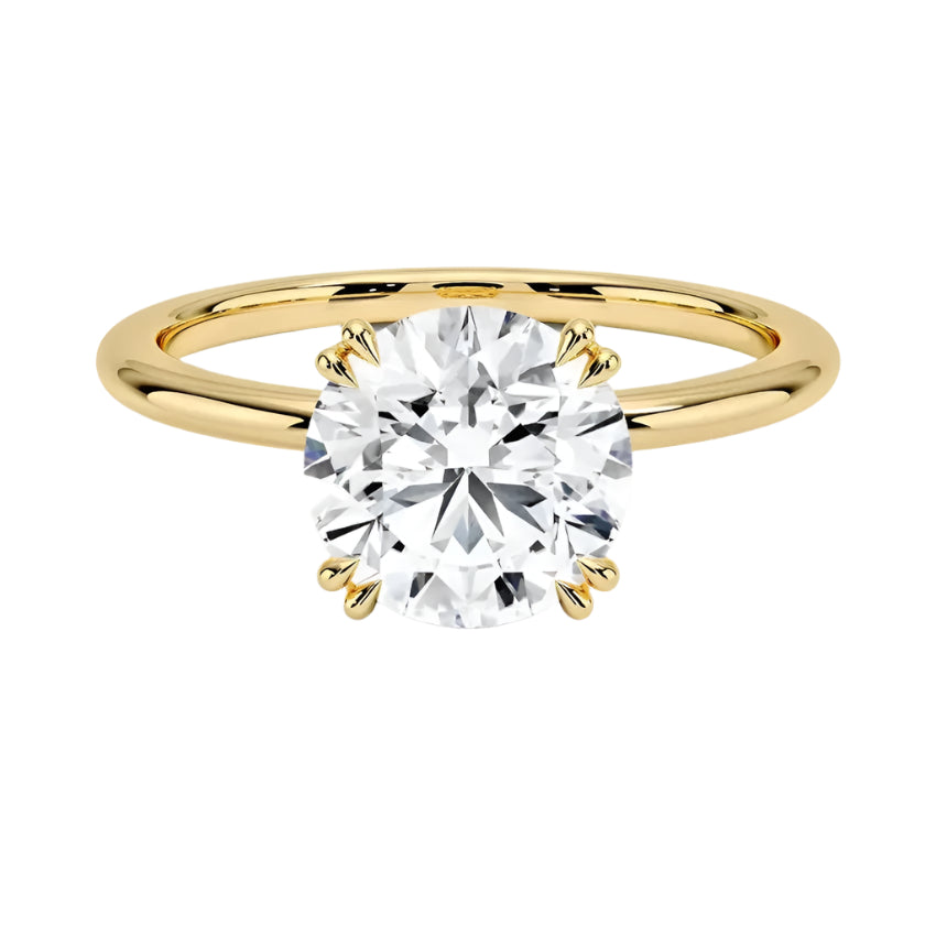 Engagement ring round cut Moissanite lab grown diamond round shank with a four cat double claw setting, on a gold band, against a white background.Moissanite engagement ring cape town south africa grand diamonds ralph jacobs jeulia 