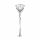 Engagement ring round cut Moissanite lab grown diamond round shank with a four cat double claw setting, on a gold band, against a white background.Moissanite engagement ring cape town south africa grand diamonds ralph jacobs jeulia 