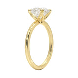 Engagement ring round cut Moissanite lab grown diamond round shank with a four cat double claw setting, on a gold band, against a white background.Moissanite engagement ring cape town south africa grand diamonds ralph jacobs jeulia 