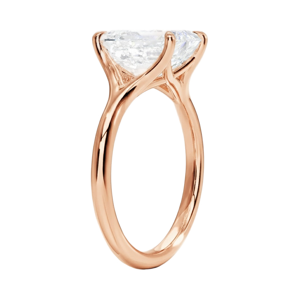 Engagement ring Round cut Moissanite lab grown diamond engagement ring v-Split round shank with a four cat-claw setting, on a gold band, against a white background.Moissanite engagement ring cape town south africa grand diamonds ralph jacobs jeulia 