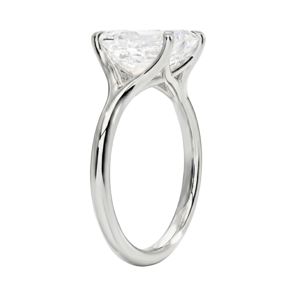 Engagement ring Round cut Moissanite lab grown diamond engagement ring v-Split round shank with a four cat-claw setting, on a gold band, against a white background.Moissanite engagement ring cape town south africa grand diamonds ralph jacobs jeulia 