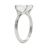 Engagement ring Round cut Moissanite lab grown diamond engagement ring v-Split round shank with a four cat-claw setting, on a gold band, against a white background.Moissanite engagement ring cape town south africa grand diamonds ralph jacobs jeulia 