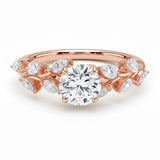 Round cut Moissanite lab grown diamond engagement ring with fancy set small pear moissanite stones on the shank, on a gold band, against a white background.Moissanite engagement ring cape town south africa grand diamonds ralph jacobs jeulia 