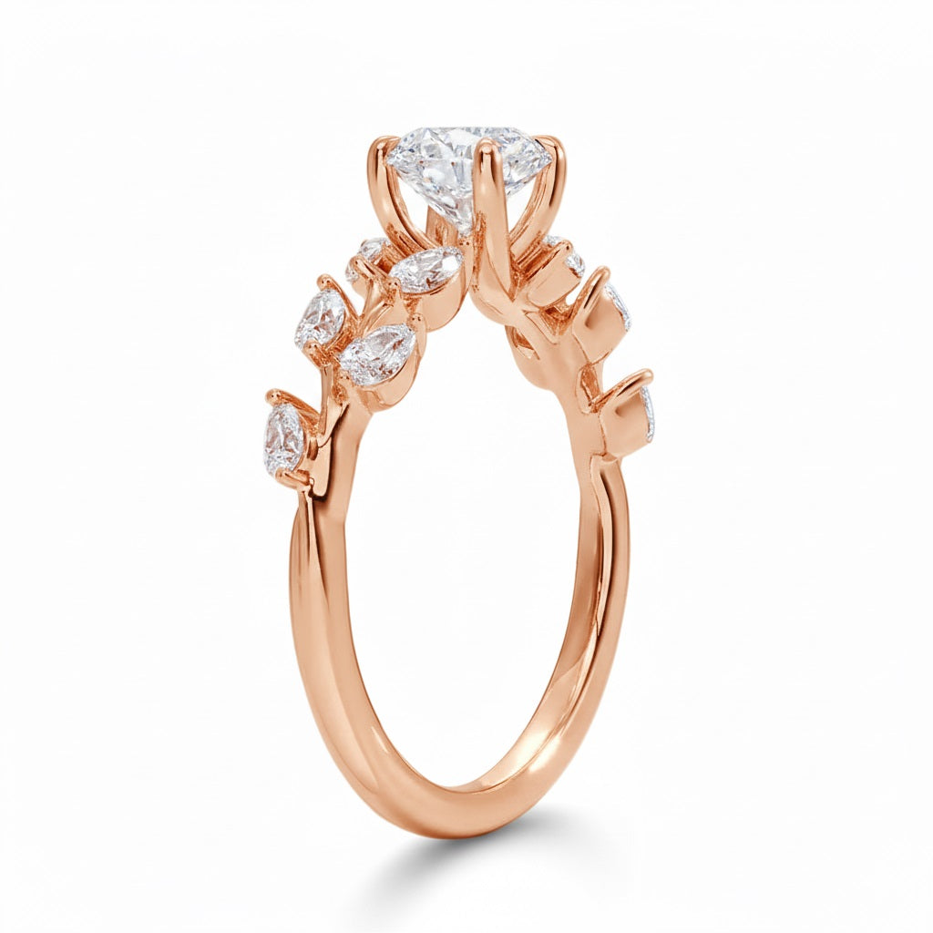 Round cut Moissanite lab grown diamond engagement ring with fancy set small pear moissanite stones on the shank, on a gold band, against a white background.Moissanite engagement ring cape town south africa grand diamonds ralph jacobs jeulia 