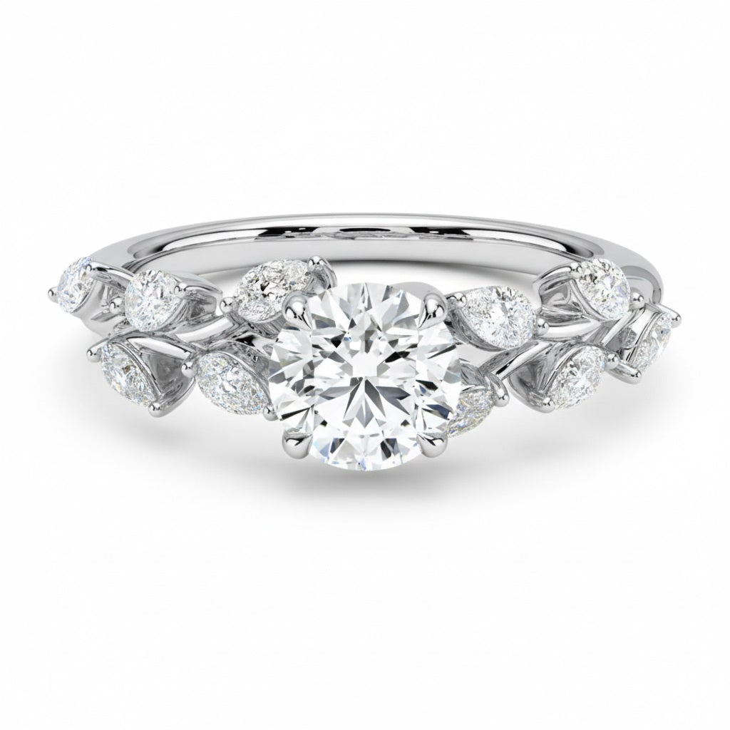 Round cut Moissanite lab grown diamond engagement ring with fancy set small pear moissanite stones on the shank, on a gold band, against a white background.Moissanite engagement ring cape town south africa grand diamonds ralph jacobs jeulia 