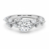 Round cut Moissanite lab grown diamond engagement ring with fancy set small pear moissanite stones on the shank, on a gold band, against a white background.Moissanite engagement ring cape town south africa grand diamonds ralph jacobs jeulia 