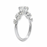 Round cut Moissanite lab grown diamond engagement ring with fancy set small pear moissanite stones on the shank, on a gold band, against a white background.Moissanite engagement ring cape town south africa grand diamonds ralph jacobs jeulia 