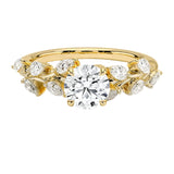 Round cut Moissanite lab grown diamond engagement ring with fancy set small pear moissanite stones on the shank, on a gold band, against a white background.Moissanite engagement ring cape town south africa grand diamonds ralph jacobs jeulia 