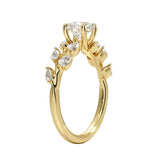 Round cut Moissanite lab grown diamond engagement ring with fancy set small pear moissanite stones on the shank, on a gold band, against a white background.Moissanite engagement ring cape town south africa grand diamonds ralph jacobs jeulia 