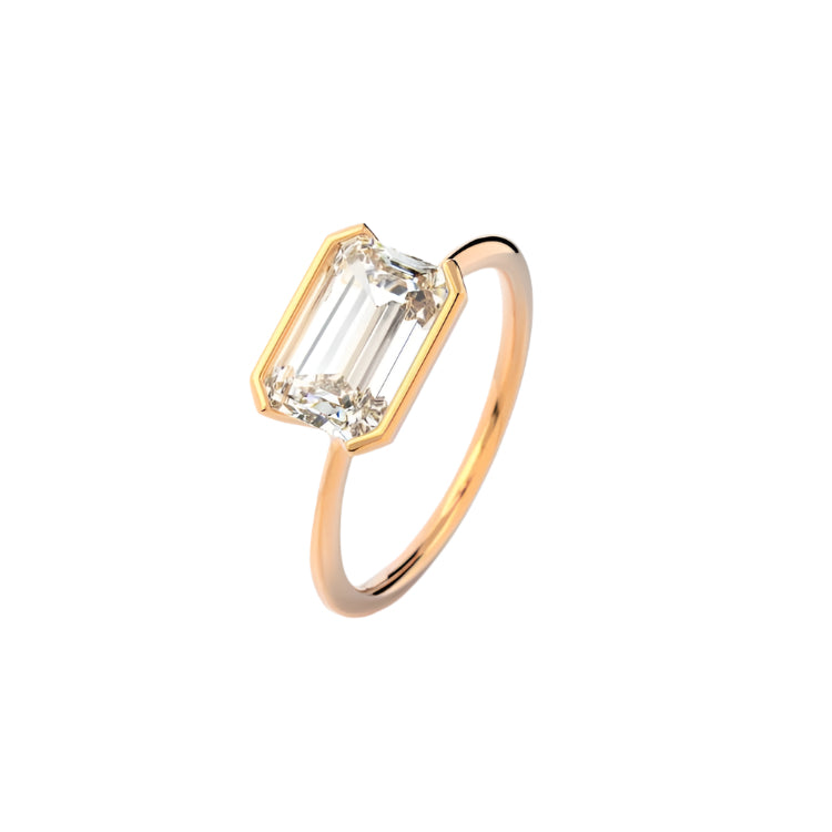 Emerald cut Moissanite lab grown diamond engagement ring column clean sophisticated design on a gold band, against a white background.Moissanite engagement ring cape town south africa grand diamonds ralph jacobs jeuli