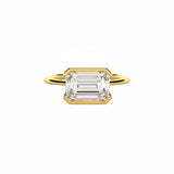 Emerald cut Moissanite lab grown diamond engagement ring column clean sophisticated design on a gold band, against a white background.Moissanite engagement ring cape town south africa grand diamonds ralph jacobs jeuli