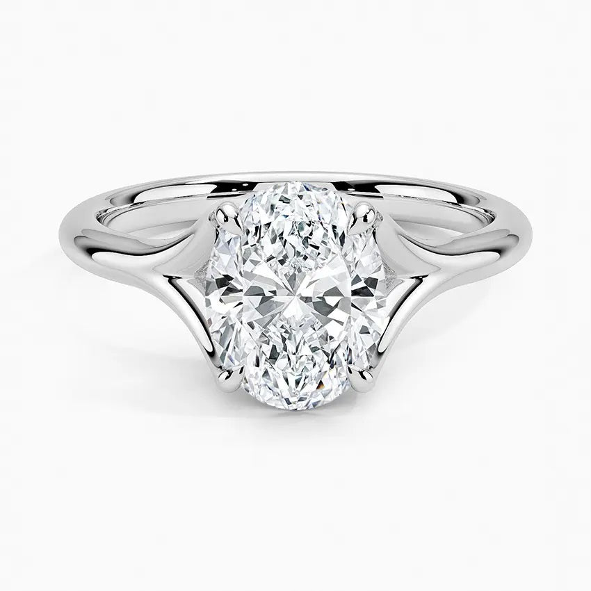 Engagement ring oval cut Moissanite lab grown diamond v-split shank with a four cat claw setting, on a gold band, against a white background.Moissanite engagement ring cape town south africa grand diamonds ralph jacobs jeulia 