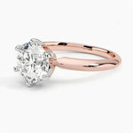 Round cut Moissanite lab grown diamond engagement ring round shank with a six claw setting, on a gold band, against a white background.Moissanite engagement ring cape town south africa grand diamonds ralph jacobs jeuli