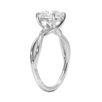 Round cut Moissanite lab grown diamond engagement ring twisted shank with a four cat-claw setting, on a gold band, against a white background.Moissanite engagement ring cape town south africa grand diamonds ralph jacobs jeuli