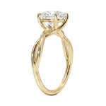 Round cut Moissanite lab grown diamond engagement ring twisted shank with a four cat-claw setting, on a gold band, against a white background.Moissanite engagement ring cape town south africa grand diamonds ralph jacobs jeuli