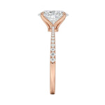 Top-down view of a D-color VVS1 oval stone in a polished rose gold tapering pavé setting.