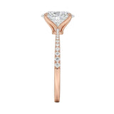 Top-down view of a D-color VVS1 oval stone in a polished rose gold tapering pavé setting.
