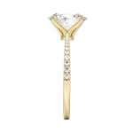 Top-down view of a D-color VVS1 oval stone in a polished yellow gold tapering pavé setting.
