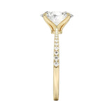 Top-down view of a D-color VVS1 oval stone in a polished yellow gold tapering pavé setting.