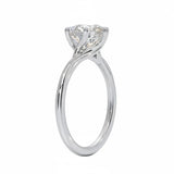 Round cut Moissanite lab grown diamond engagement ring round shank with a six claw setting, on a gold band, against a white background.Moissanite engagement ring cape town south africa grand diamonds ralph jacobs jeulia 