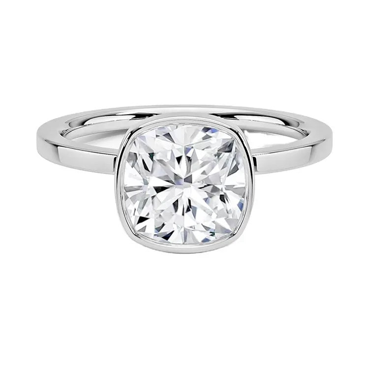 Cushion cut Moissanite engagement ring with a bezel setting, displayed on a gold band, against a white background.Moissanite engagement ring cape town south africa grand diamonds ralph jacobs jeulia 