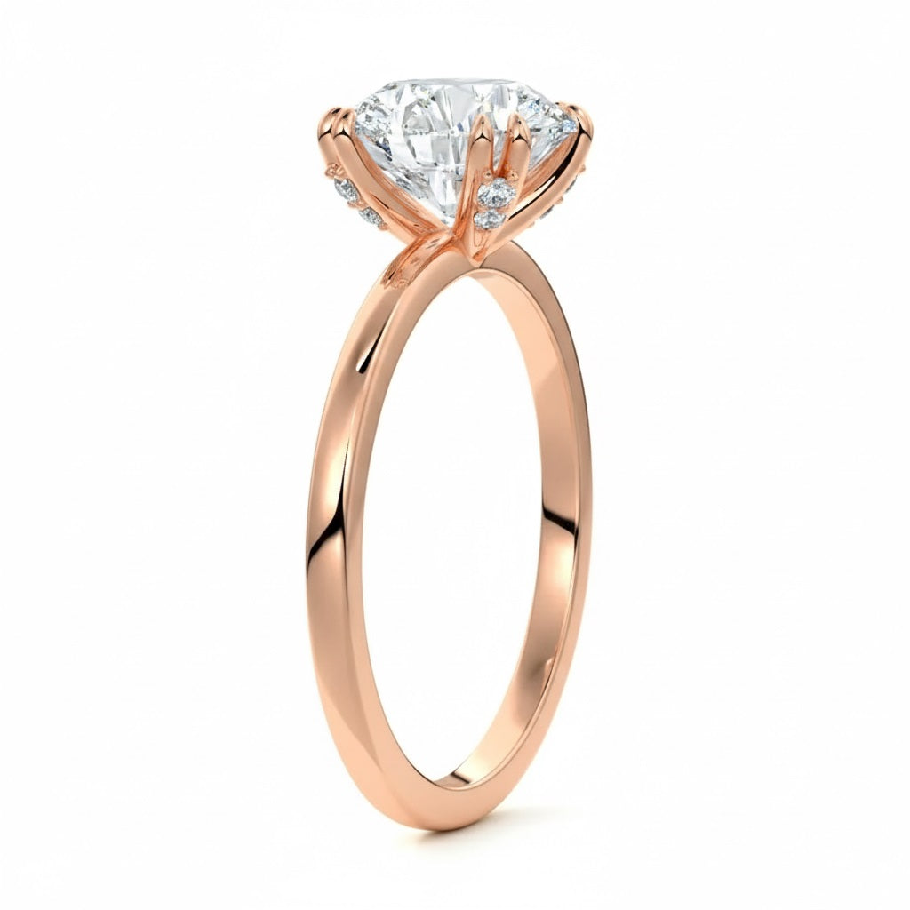 Engagement ring round cut Moissanite lab grown diamond engagement ring round shank with four  double cat law setting, on a gold band, against a white background.Moissanite engagement ring cape town south africa grand diamonds ralph jacobs jeulia 