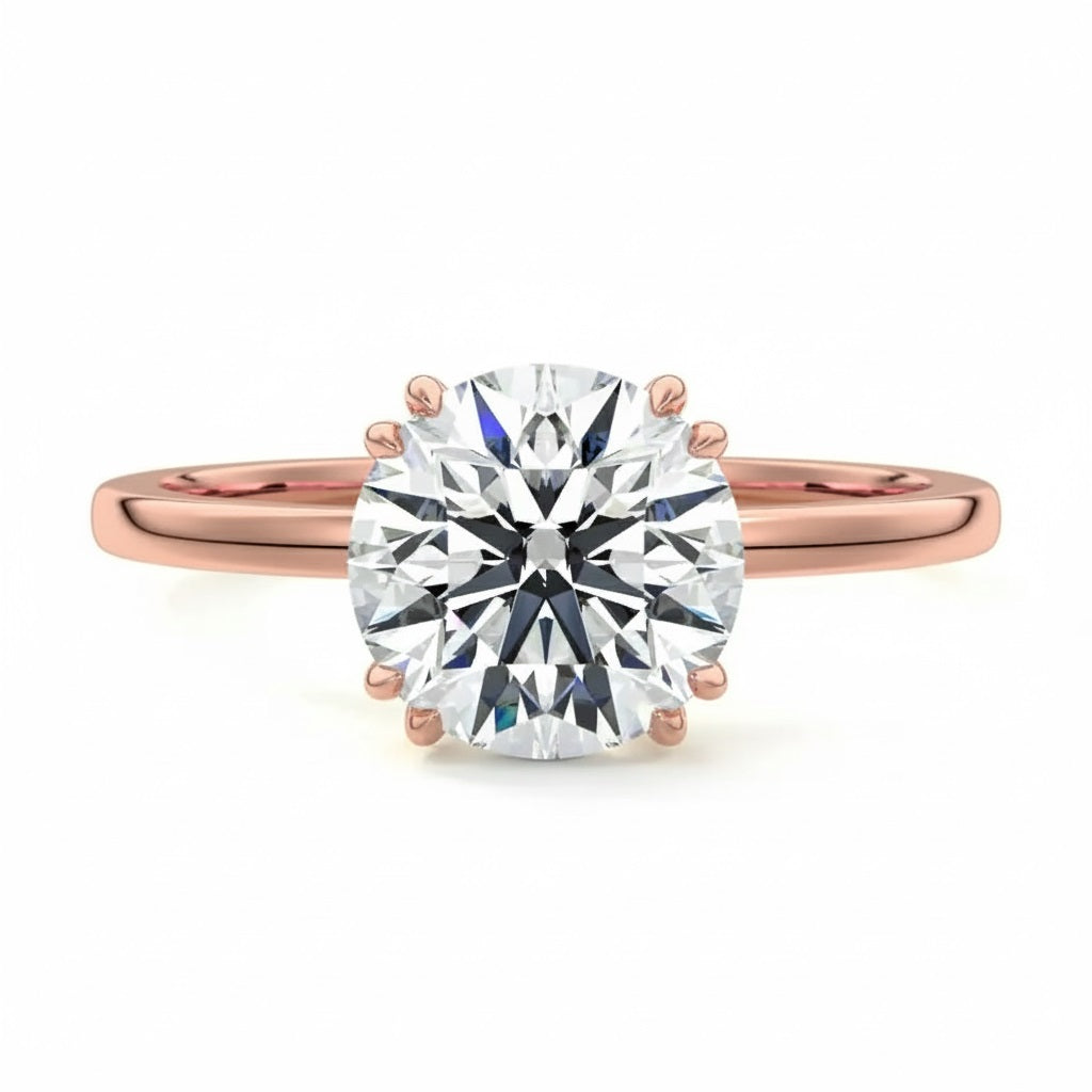 Engagement ring round cut Moissanite lab grown diamond engagement ring round shank with four  double cat law setting, on a gold band, against a white background.Moissanite engagement ring cape town south africa grand diamonds ralph jacobs jeulia 